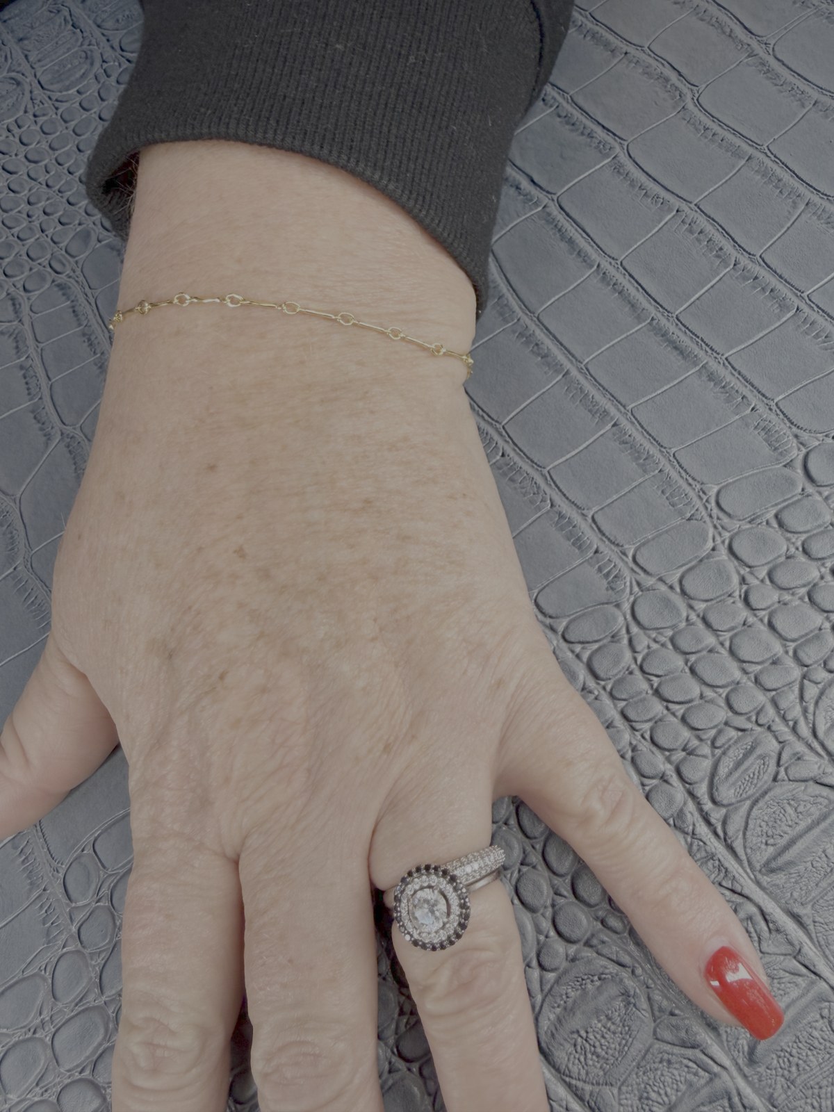 A wrist wearing a delicate chain bracelet