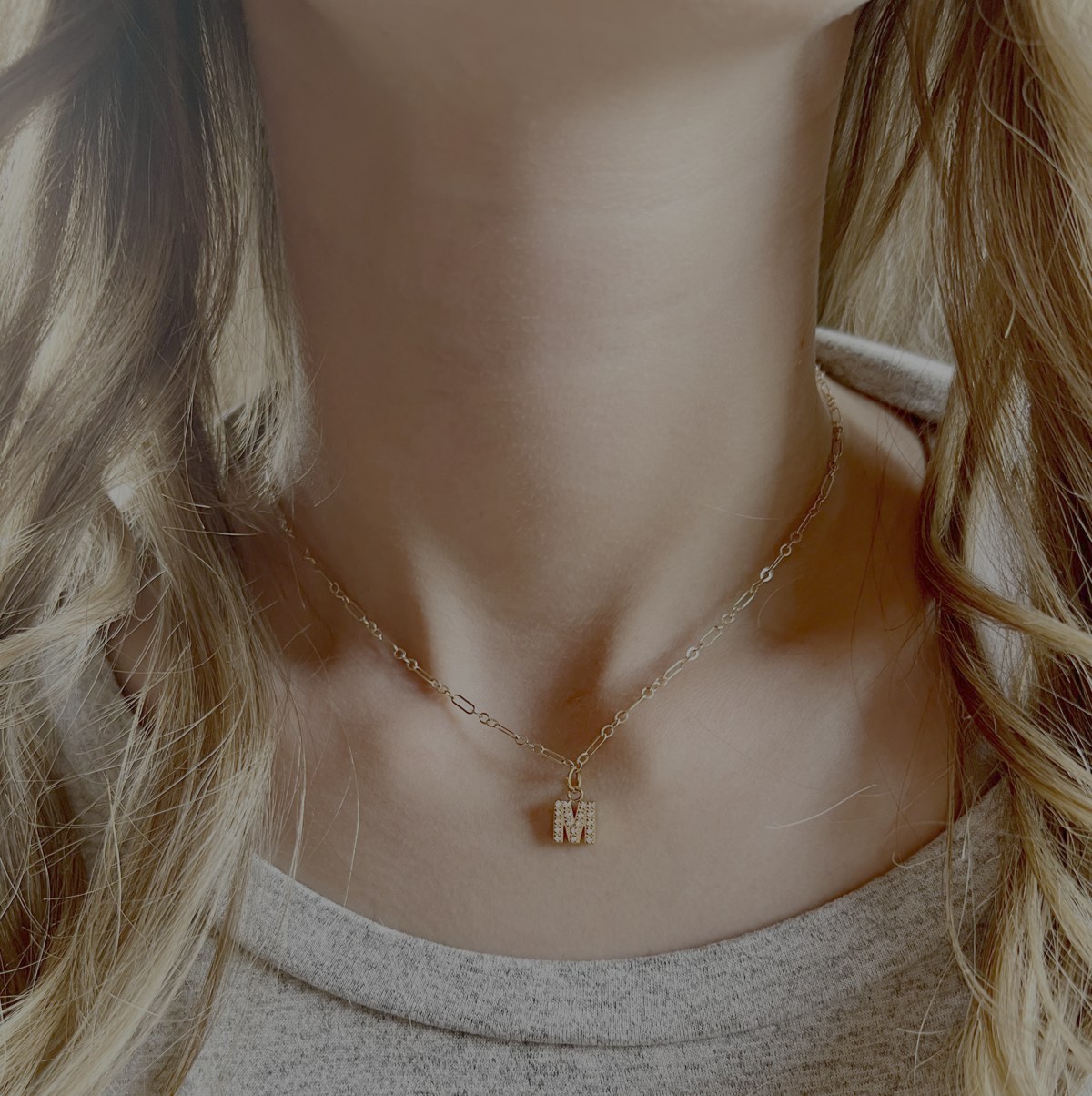 Gold chain necklace with small dangling charms